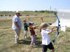 Jim Carter instructs a young trio of archers